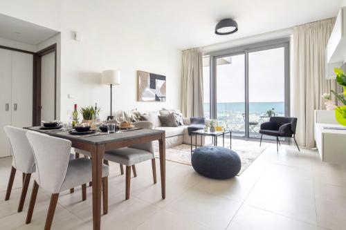 a living room with a table and a couch at Frank Porter - 1 Residences in Dubai