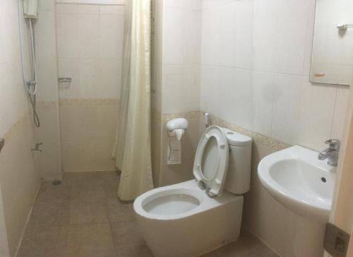 a bathroom with a toilet and a sink at Triple Palms House in Chiang Mai