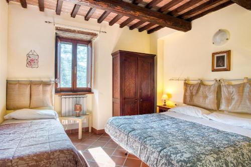 1 dormitorio con 2 camas y ventana en Bosco ad Antico Casale '700, en Umbertide