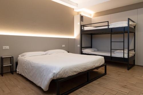a bedroom with a bed and a bunk bed at Hotel Astoria in Ravenna
