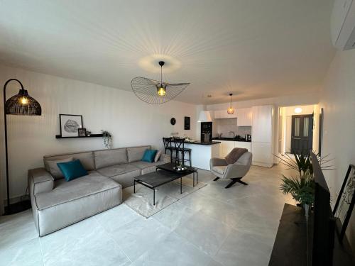 a living room with a couch and a kitchen at Penthouse i sjøkanten på Dejablue in Kyrenia