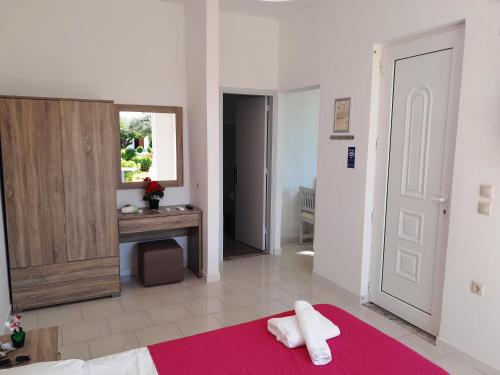 a bedroom with a bed with a towel on it at Villa Maroula in Afantou