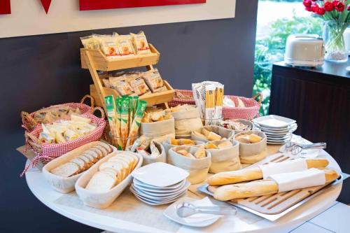 a table topped with lots of different types of food at AN Hotel Milano Melegnano in Carpiano