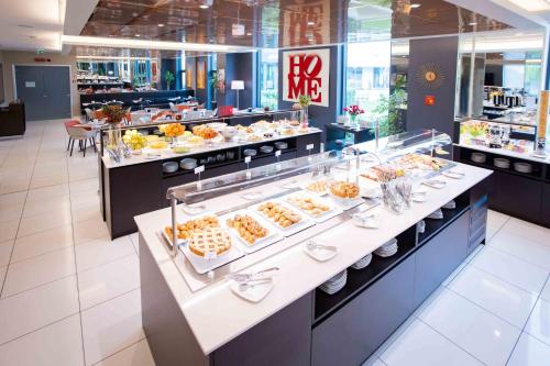 a buffet line with a lot of food on display at AN Hotel Milano Melegnano in Carpiano