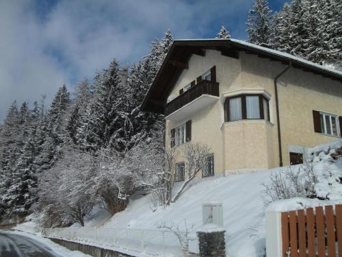 a house on a snow covered hill with trees at Ferienwohnung in ruhiger Lage am Waldrand - b55795 in Navis