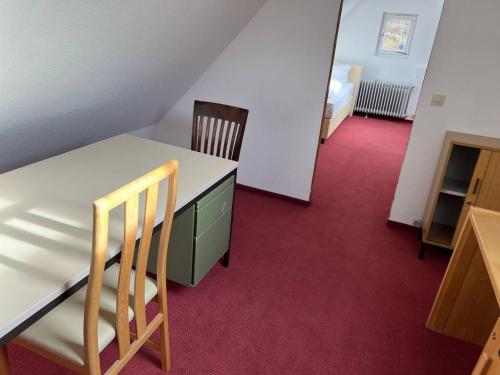 a room with a table and two chairs and a bedroom at Room in Guest room - Pension Forelle - double room n01 in Forbach