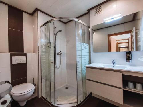 a bathroom with a shower and a toilet and a sink at Gasthof Blankenberg 