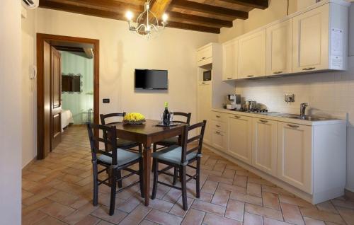a kitchen with a table and chairs in a room at Appartement in Scandiano mit Privatem Parkplatz - b57352 in Scandiano