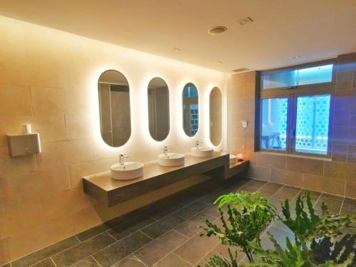 łazienka z 3 umywalkami i 3 lustrami w obiekcie The Sóng Vũng Tàu Melon Home w mieście Vung Tau