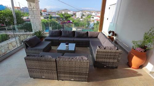 a living room with a couch and chairs on a balcony at Luxury Villa Levanda in Ksamil