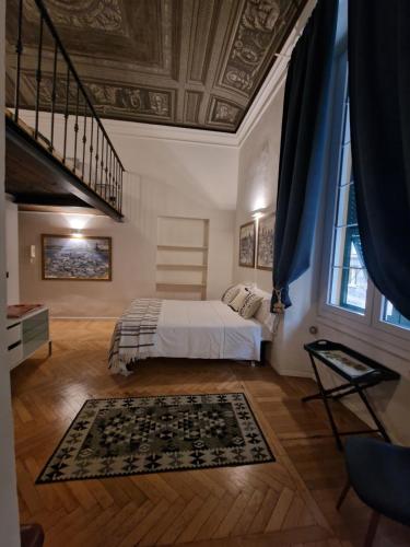 a bedroom with a bed and a staircase in a room at Residenza Allegra in Genova