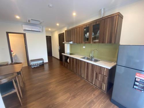 a kitchen with a sink and a refrigerator at SweetHome Long Biên in Hanoi