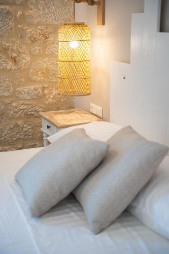 a bedroom with a bed with a pillow on it at Olvio Suites in Kardamili