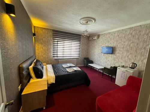 a hotel room with a bed and a couch at ENJOY HOUSE BOUTİQE OTEL in Ankara