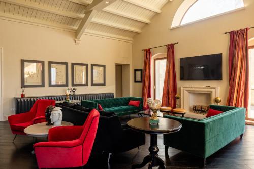a living room with couches and chairs and a fireplace at Alvino Relais Mulino Contemporaneo in Matera