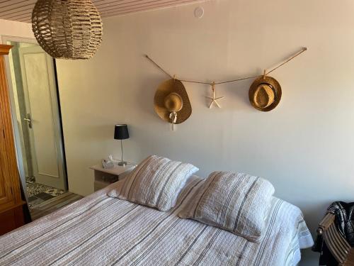 a bedroom with a bed with two pillows on it at Petite maison dans la manche in Créances