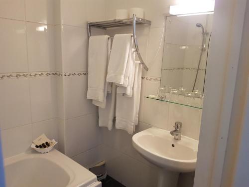 a white bathroom with a sink and a toilet at Victoria Park Lodge in Leamington Spa