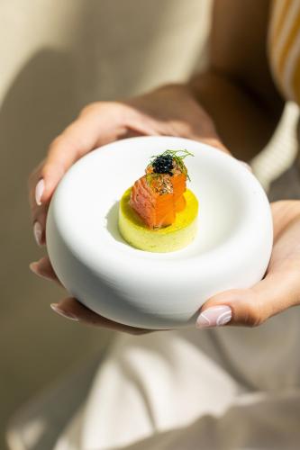 a person holding a plate with a dessert on it at Alvino Relais Mulino Contemporaneo in Matera