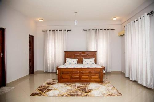 a bedroom with a bed and a rug at Masaki Seaside Charm: Spacious Hideaway in Dar es Salaam