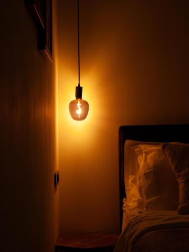 a light bulb in a dark room next to a bed at NOVA LUXURY DESIGN in Zagreb