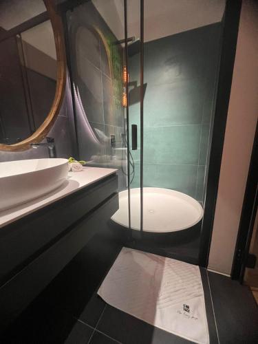 a bathroom with a shower and a sink and a tub at NOVA LUXURY DESIGN in Zagreb