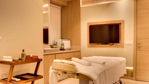 a bathroom with a tv and a massage at The Greenwood Guwahati - A Luxury Boutique Hotel in Guwahati
