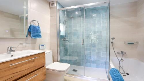 a bathroom with a shower and a toilet and a sink at Bellresguard Garden Flat C in Port de Pollensa