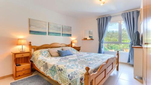 a bedroom with a bed and a window at Bellresguard Garden Flat C in Port de Pollensa