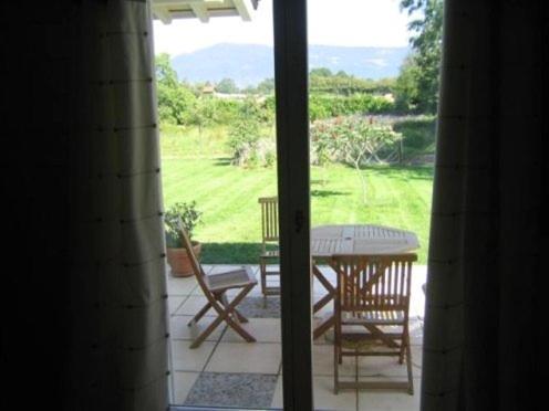 a view of a patio with a table and chairs at BnB Atelier de St. Maurice in Vésenaz