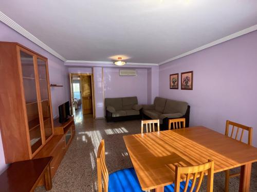 a living room with a table and a couch at Apartamentos Villa de Ainsa in Aínsa