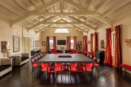 a dining room with a table and red chairs at Alvino Relais Mulino Contemporaneo in Matera
