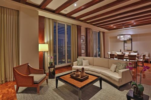 a living room with a couch and a table at InterContinental Costa Rica at Multiplaza Mall by IHG in San José
