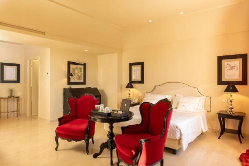 a bedroom with a bed and a table and chairs at Alvino Relais Mulino Contemporaneo in Matera
