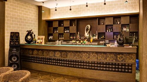 a bar in a restaurant with a counter and chairs at The Greenwood, Tezpur in Tezpur