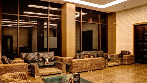 a lobby with couches and tables in a building at The Greenwood, Tezpur in Tezpur