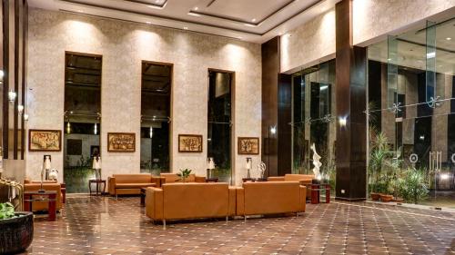 a lobby of a hotel with chairs and tables at The Greenwood, Tezpur in Tezpur