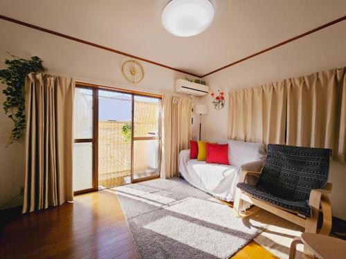 a living room with a couch and a window at AsahiStay -Koiwa, Free parking O, Whole Family House, Japanese garden taste in Tokyo
