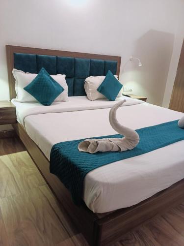 a large bed with a snake laying on it at CT ROOMS JAMAL ROAD by CLOVETREE in Patna