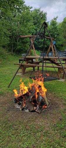a pile of fire in front of a picnic table at Sauerland-AlmWinterberg in Hallenberg
