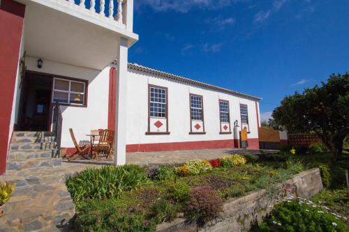 PuntallanaにあるJuanitaの白と赤の建物(テーブルと椅子付)
