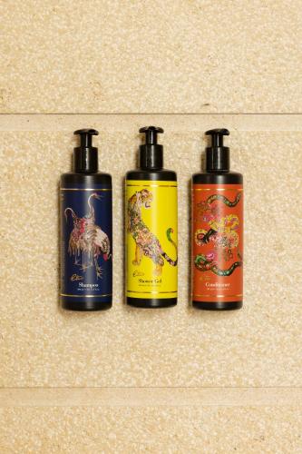 a group of three shampoo bottles on a wall at Alvino Relais Mulino Contemporaneo in Matera