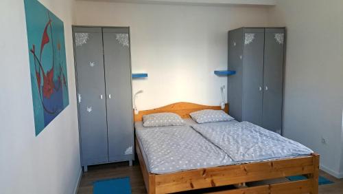 a bedroom with a bed and two closets at Dimora Apartments with free parking in Ljubljana