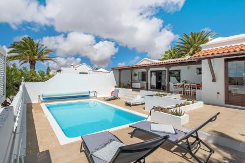 a villa with a swimming pool and a house at Casa Carmen - Comfort and Privacy in Nazaret
