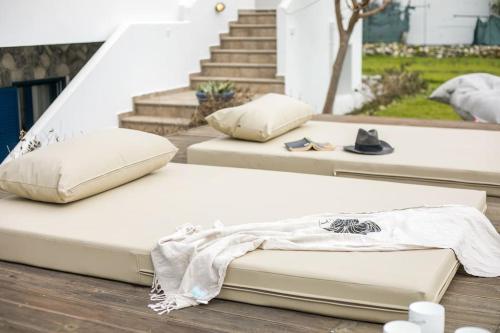 a mattress sitting on top of a wooden deck at Villa Kaya in Haraki
