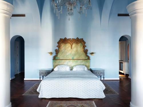 a bedroom with a large bed in a blue wall at La Maison Bleue El Gouna in Hurghada