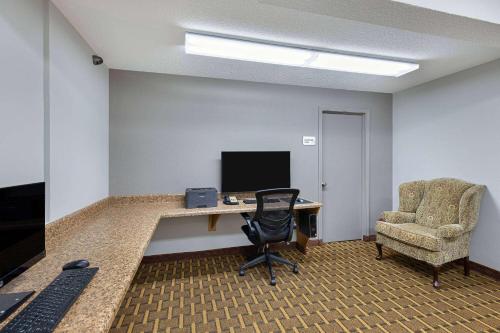 an office with a desk and a chair and a computer at Ramada by Wyndham Bowling Green in Bowling Green