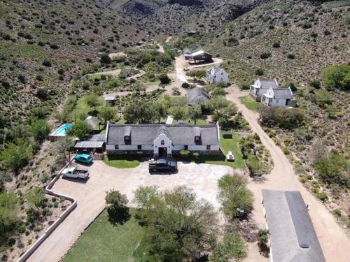 an aerial view of a large house in the mountains at Bushman Valley in Prince Albert