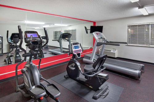 a gym with several treadmills and cardio machines at Ramada by Wyndham Bowling Green in Bowling Green