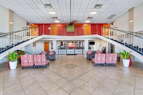 an empty lobby with chairs and a staircase at Ramada by Wyndham Bowling Green in Bowling Green