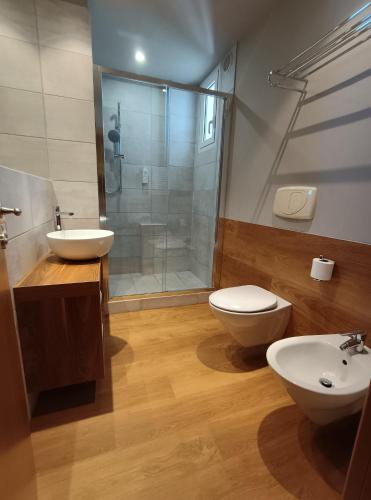 a bathroom with a shower and a toilet and a sink at Hotel Concord - Nel cuore di Riccione in Riccione